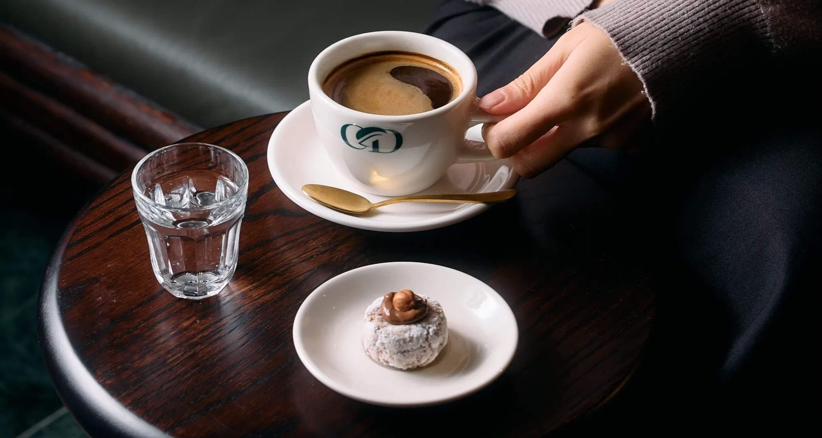 black coffee and biscotti on plate on cafe table